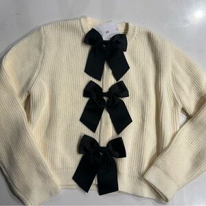 Elegant Cream Sweater with Black Bow Accents